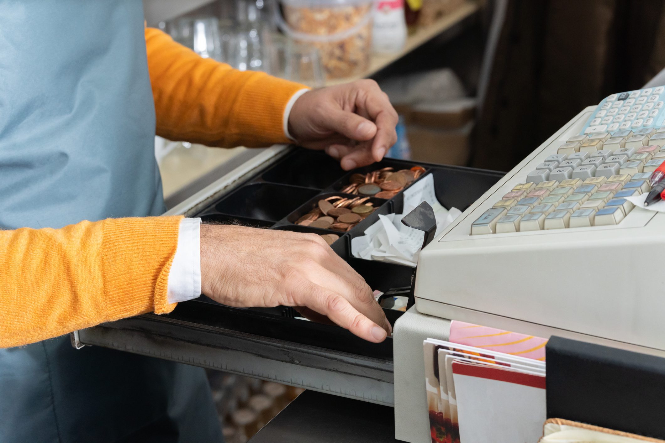 Cashier handling money at register