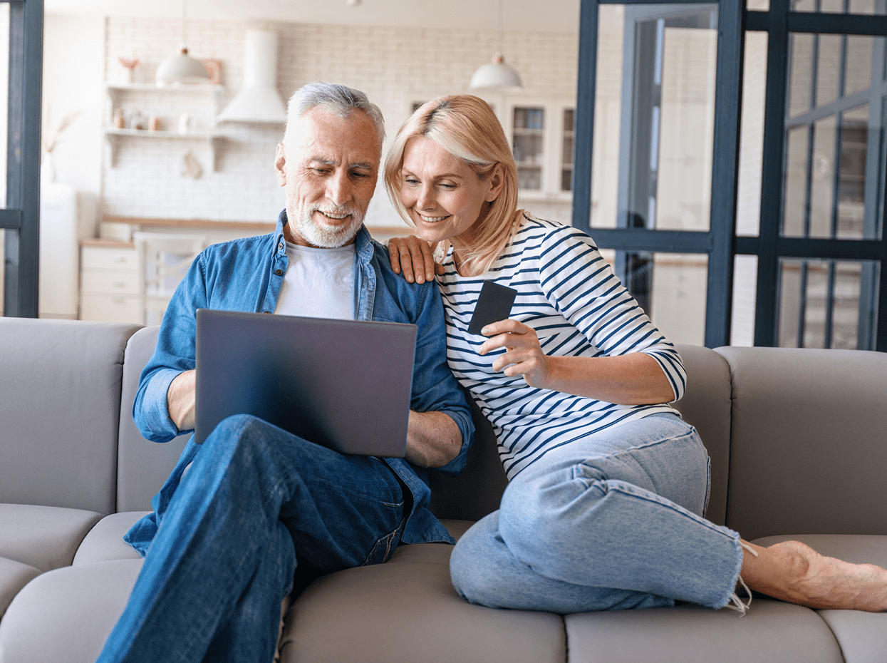 Couple shopping online with laptop